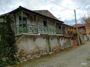 an old house with a balcony on a street at Stunning House in Mirandela ideal for 10 people in Mirandela