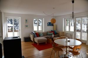 a living room with a couch and a table at Edelstein Apartments in Turracher Hohe