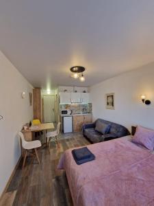 a bedroom with a bed and a living room at New Gudauri, Apartment 244 in Gudauri