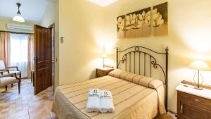 a bedroom with a bed with white shoes on it at Alojamiento Rural El Salto Villafranca de Córdoba by Ruralidays in Córdoba +20 photos