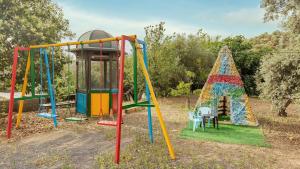a group of playground equipment in a park at Alojamiento Rural El Salto Villafranca de Córdoba by Ruralidays in Córdoba