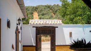 an open door to a house with a view at Cortijo El Prado Villanueva de Algaidas by Ruralidays in Villanueva de Algaidas