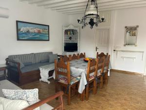a living room with a table and chairs and a couch at Sole Mykonos in Mikonos