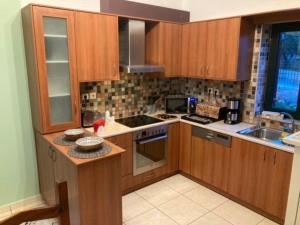 a kitchen with wooden cabinets and a counter top at Villa Pascale in Hersonissos