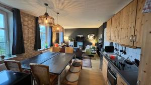 a kitchen with a table and a living room at Ferienhaus Alte Schule Niebüll in Niebüll