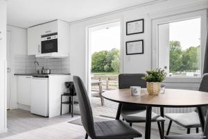 a kitchen and dining room with a table and chairs at First Camp Skönstavik Karlskrona in Karlskrona