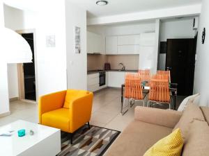 a living room with a couch and a table at Lavender Bay Apartments D3 or D5 in Donji Morinj