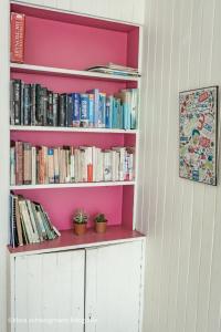 a book shelf filled with books in a room at Lost in San Jose Hotel & Hostel in San José