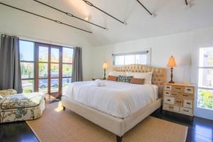 a bedroom with a large white bed and a window at Liberty Tree House in Charleston