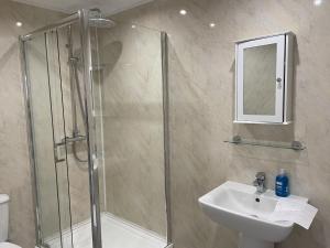 a bathroom with a shower and a sink at Diamonds Villa in York +18 photos