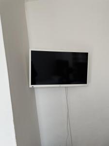 a flat screen tv hanging on a white wall at Diamonds Villa in York