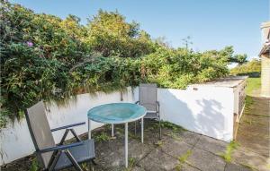 a table and chairs in front of a fence at Awesome Home In Samsø With Wifi in Nordby +20 photos