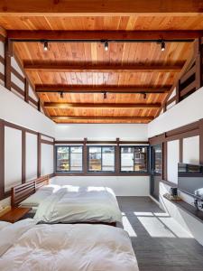 a bedroom with a large bed and wooden ceilings at Caolingdai BnB in Gukeng