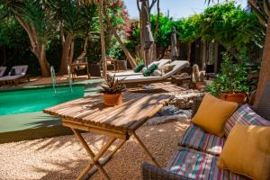 un patio con tavolo, sedie e piscina di Casa Con Destino-Adults Only a Jalón