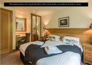 a bedroom has a large bed with white pillows which can be made with sheets at Mains of Taymouth Country Estate 5* Gallops Apartments in Kenmore