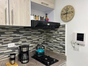 Una cocina o zona de cocina en Elegante Loft cerca a Titan Plaza y otros Malls