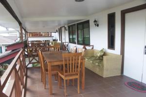 a room with a table and chairs on a balcony at Nabalu Kundasang in Kampong Kundassan