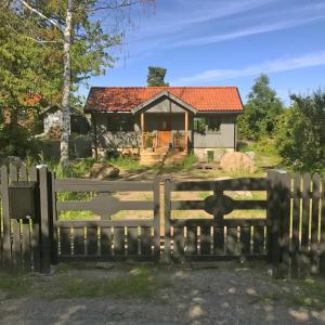 a house with a gate in front of it at Nice summer house near the sea on Lidingo in Lidingö