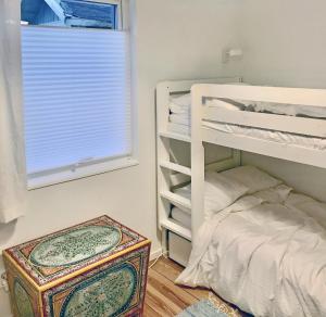 a bedroom with a bunk bed next to a window at Nice summer house near the sea on Lidingo in Lidingö