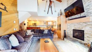 a living room with a couch and a fireplace at Sierra Megeve #7 Condo in Mammoth Lakes