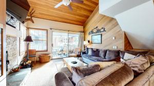 a living room with a couch and a table at Sierra Megeve #7 Condo in Mammoth Lakes