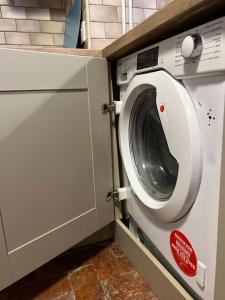 a washer and dryer in a kitchen with a counter at The Cottage, Watergate, Sleaford in Lincolnshire