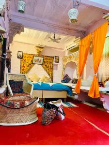 a bedroom with two beds and a red carpet at Shiva Guest House in Jaisalmer