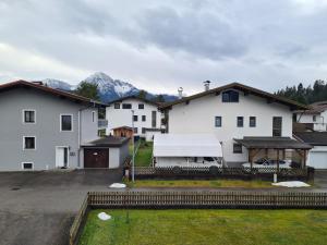 a group of white buildings with mountains in the background at Ferienwohnung Scharf in Reutte