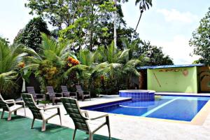 a patio with chairs and a swimming pool at Hotel & Restaurante Siami in Leticia +9 photos