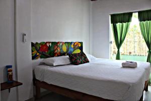 a bedroom with a large bed with a window at Hotel & Restaurante Siami in Leticia