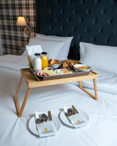 bandeja de comida encima de la cama en Brettania Hotel, en Ioannina