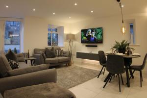 a living room with a tv on the wall at Hideaway in Great Urswick