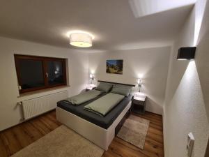 a bedroom with a large bed and a window at Ferienwohnung Scharf in Reutte