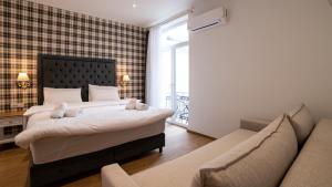 Posteľ alebo postele v izbe v ubytovaní Brettania Hotel