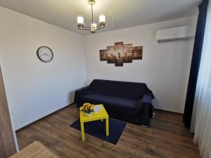 a living room with a blue couch and a table at Studio Oslo byPMM in Plovdiv