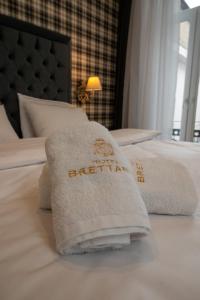 a hotel room with two towels on a bed at Brettania Hotel in Ioannina