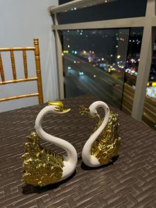 two white and gold swans on a table at Unit 1537 Bahamas tower Azure Urban Resort Residence Paranaque City in Bacoor