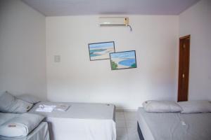 Katil atau katil-katil dalam bilik di Chalés Passagem do Canto