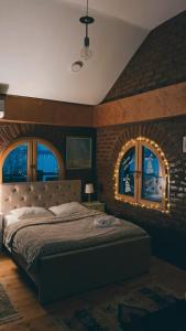 a bedroom with a large bed in a brick wall at Apartman17 in Belgrade