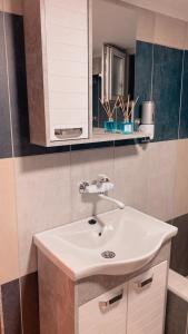 a bathroom with a white sink and a mirror at Apartman17 in Belgrade +28 photos