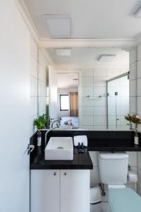 y baño con lavabo, aseo y espejo. en AA13 - Apto 2 Dorms Mobiliado c/ Vaga: Bela Vista!, en São Paulo