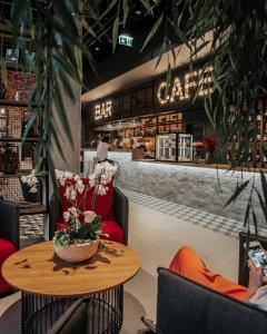 a restaurant with a table and chairs and a bar at ibis Tallinn Center in Tallinn