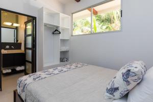 a bedroom with a bed and a window at Villa Ananda in Ballena +31 photos