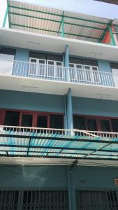 a blue building with a balcony on top of it at Freedom8 in Khlong San