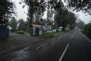 an empty street with a sign on the side of the road at Green Park Resort in Masinagudi