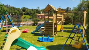 a playground with a slide and a play structure at LA GRANDA DE LA CONCHA in Nueva de Llanes