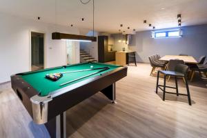 a pool table in the middle of a room at Luxury Villa Loma 2 in Sveti Vid-Miholjice