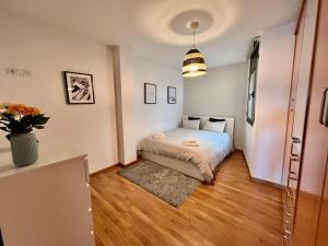a bedroom with a bed and a vase of flowers at Apartamento espacioso y familiar in Terrassa