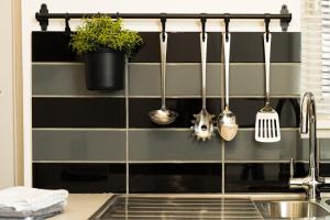 a kitchen with utensils hanging on a wall at The Old Woodyard at Syston in Syston