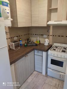 a kitchen with a sink and a stove top oven at depto itagua in Mar del Tuyú +4 photos